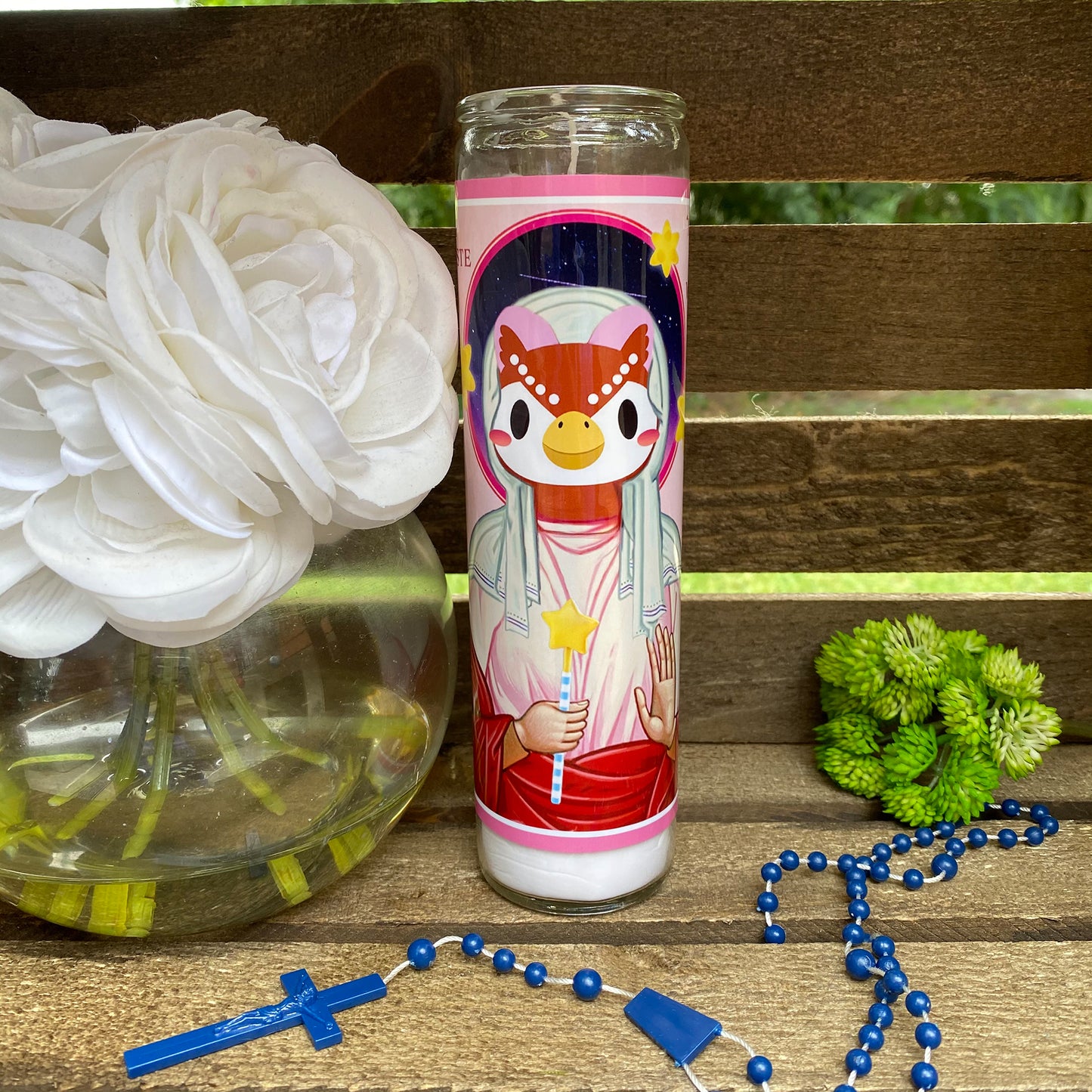 a picture of a vase with flowers and a rosary