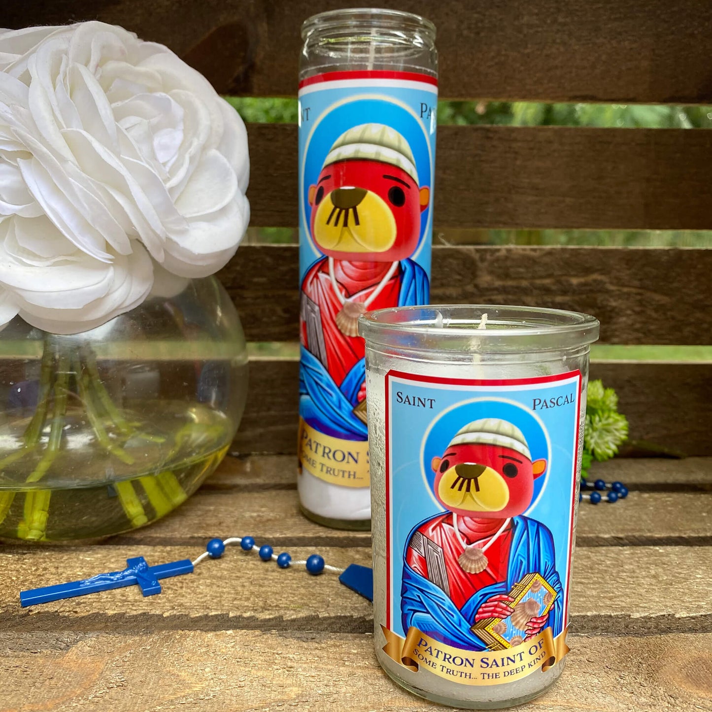 a couple of candles sitting on top of a wooden table