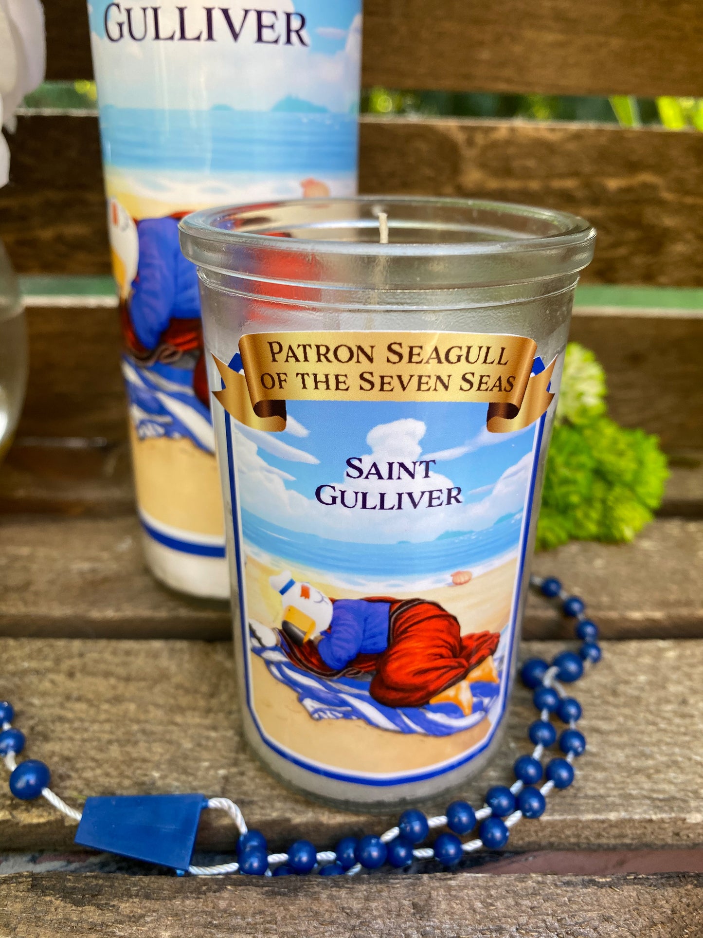 a candle is sitting on a table next to a rosary