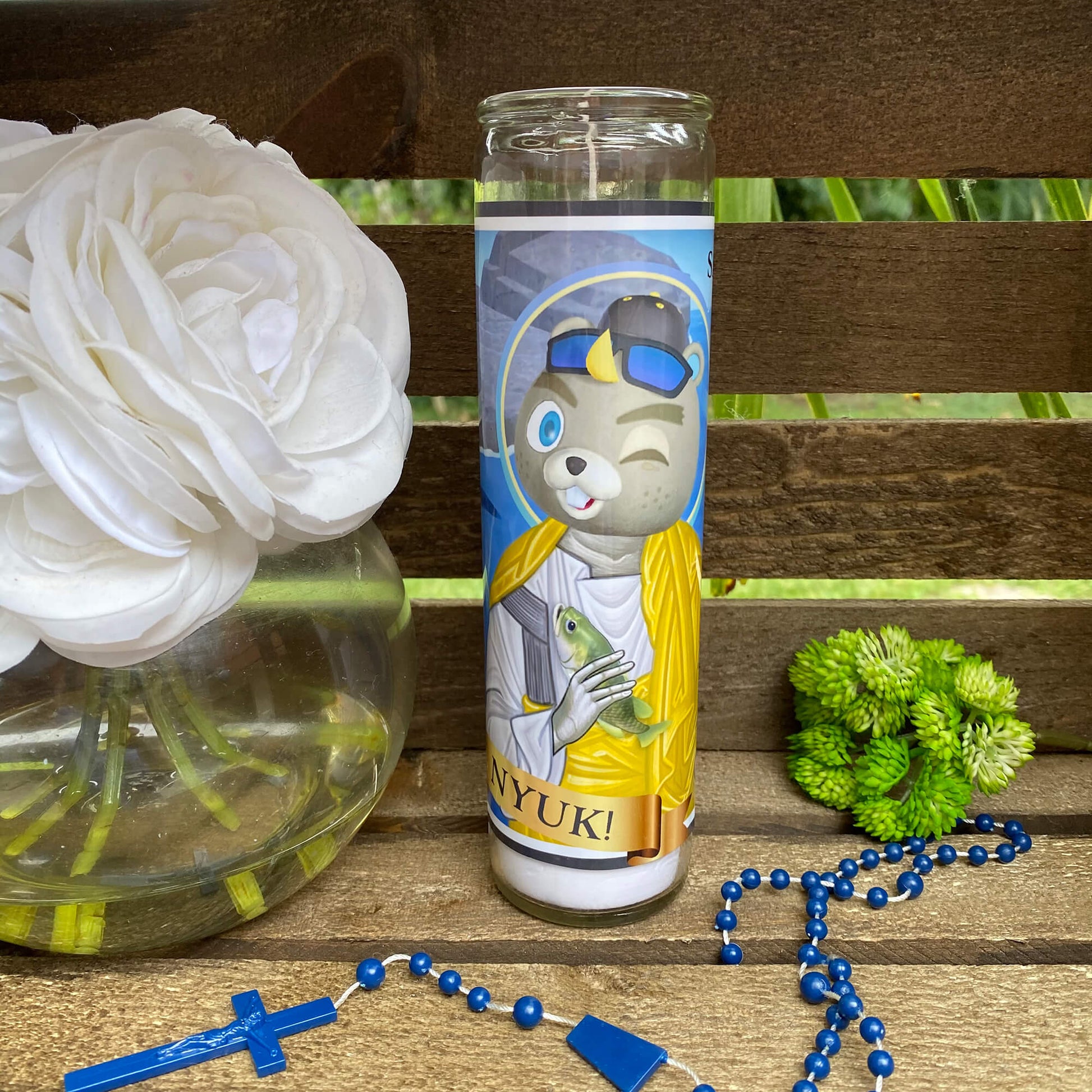 a picture of a bear with a crown on it next to a vase with flowers