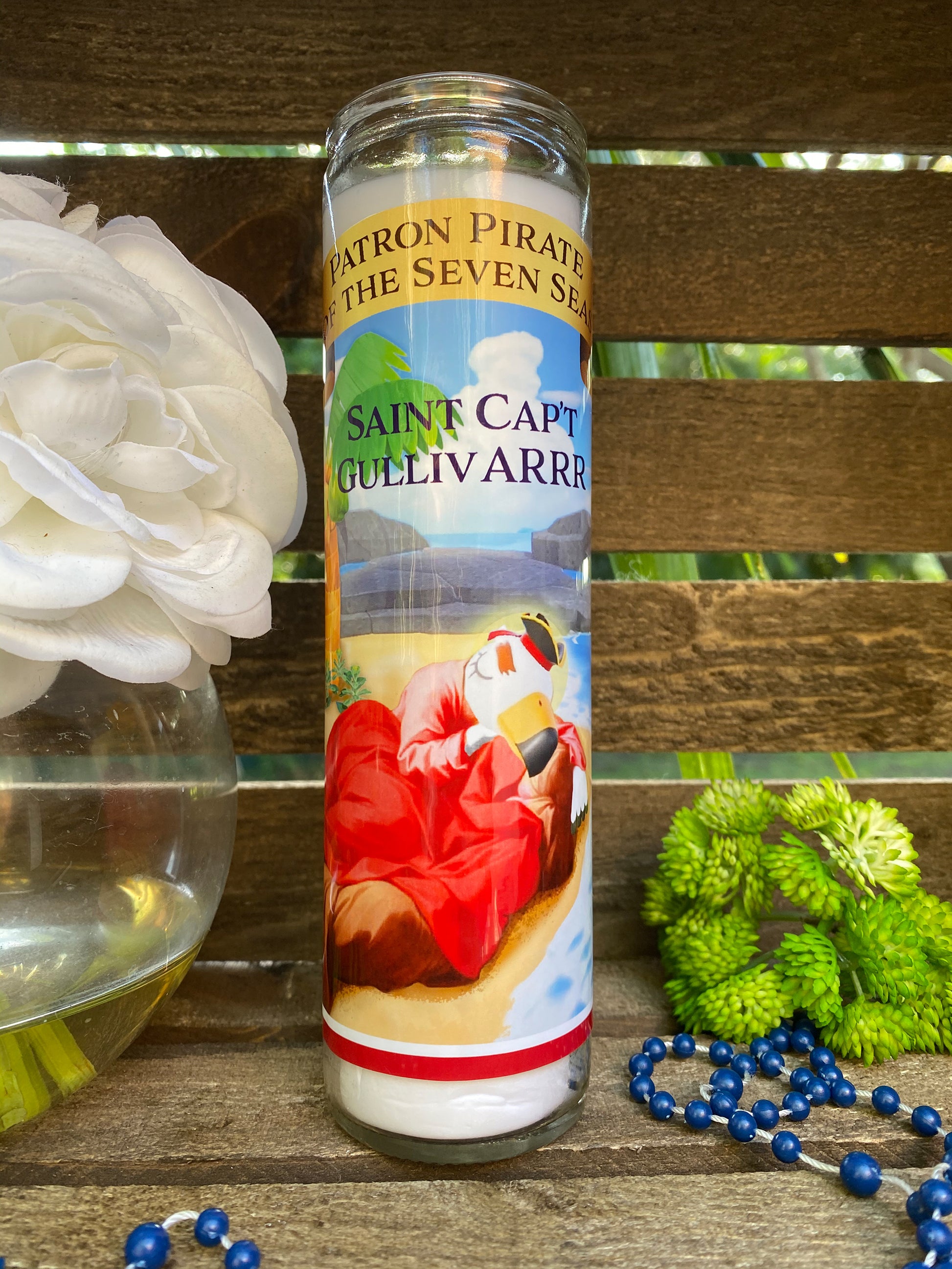 a bottle of paint next to a flower and beads