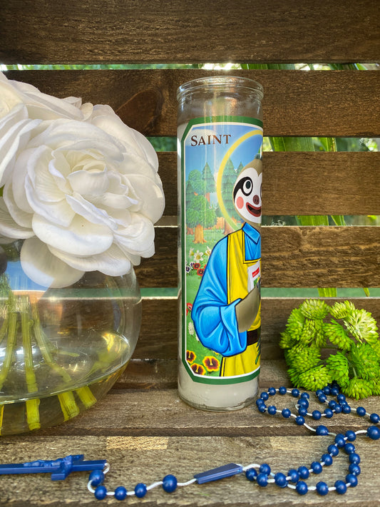 a candle and beads on a wooden table