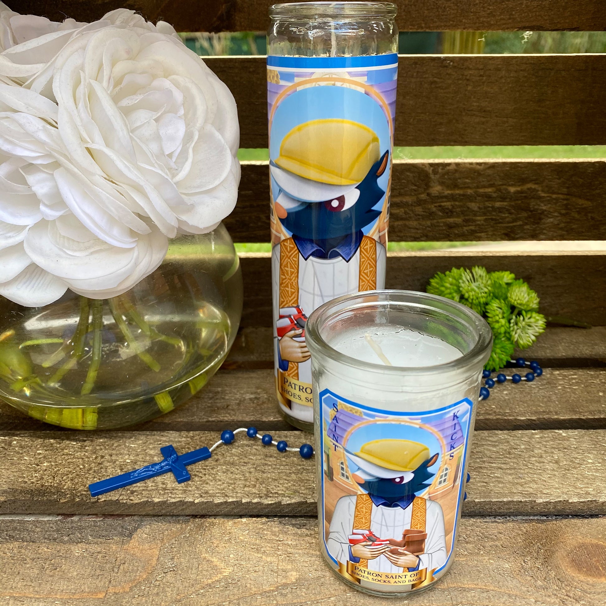 a candle and some flowers sitting on a bench