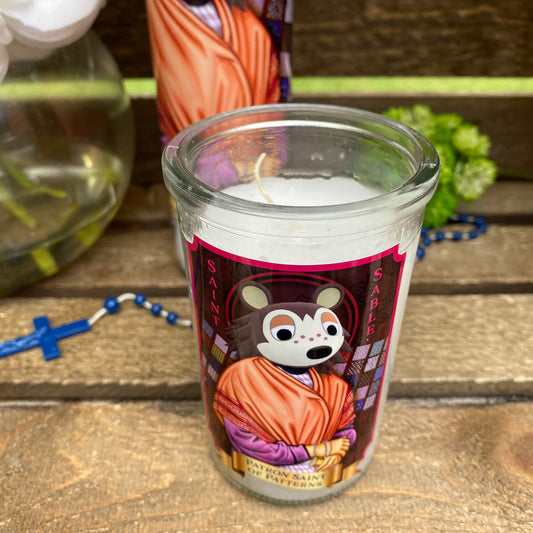 a candle with a picture of a monk on it