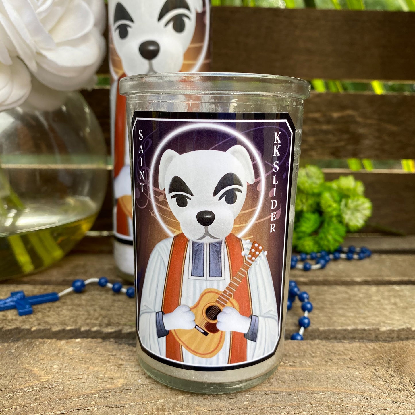 a candle with a picture of a panda playing a guitar
