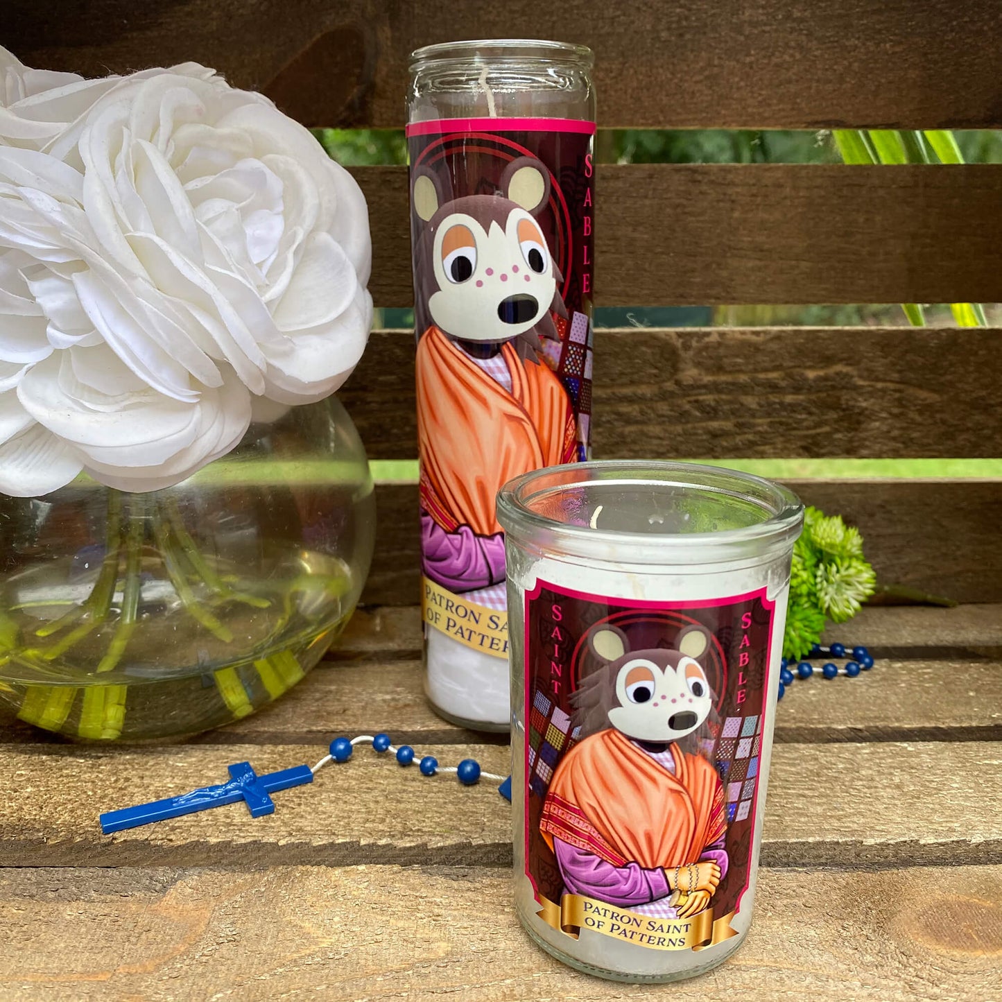 a couple of candles sitting on top of a wooden table