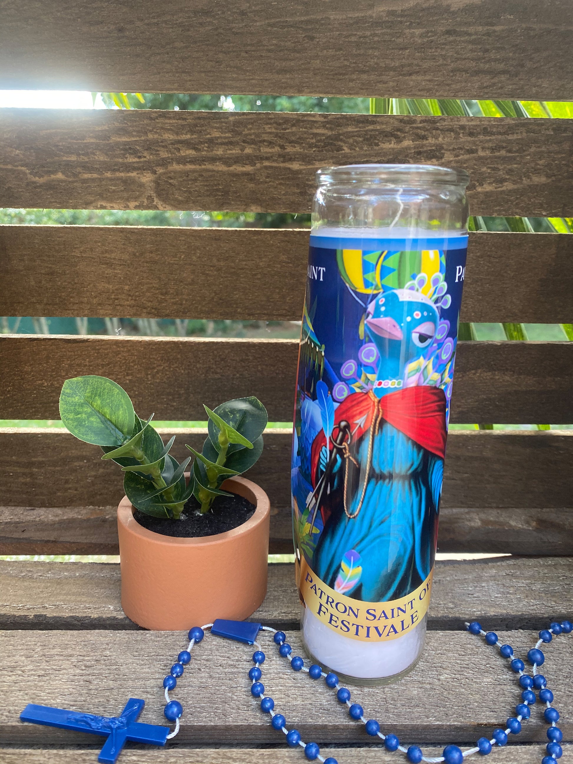 a cup of coffee next to a plant on a bench