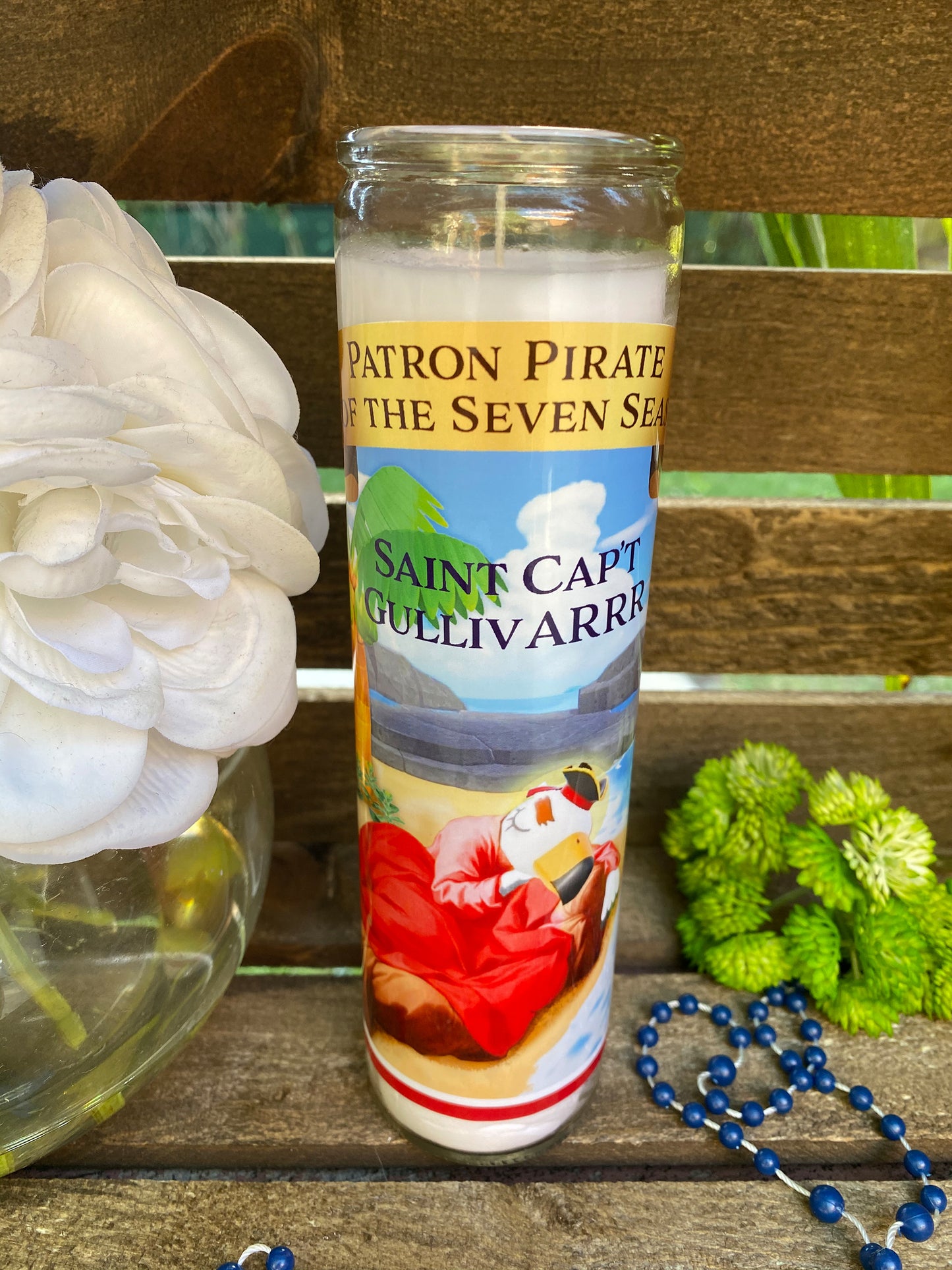 a white flower sitting next to a glass of water