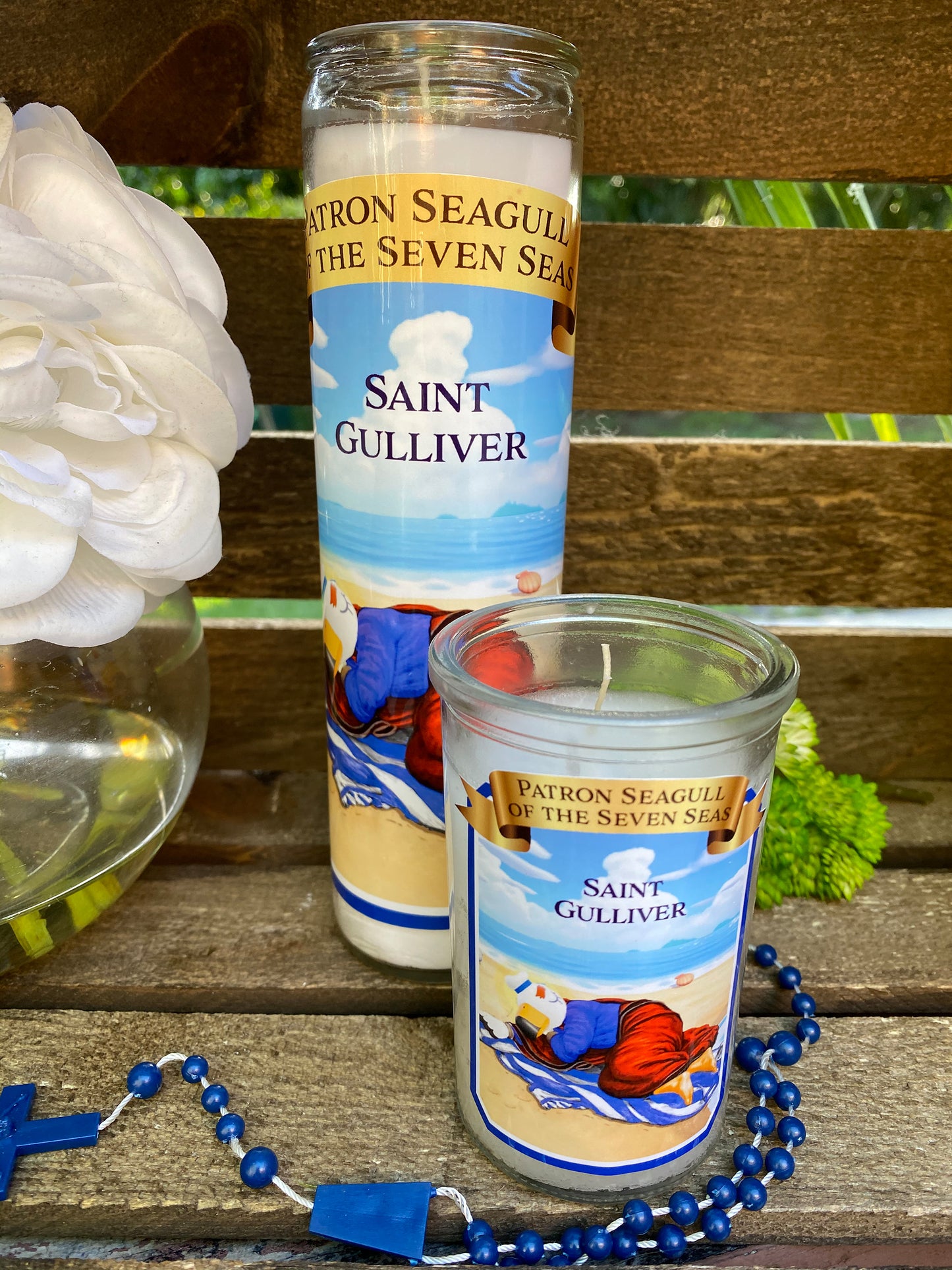 a candle and a rosary on a bench