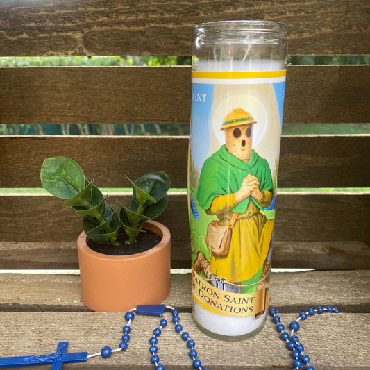 a picture of a saint benedict on a travel mug next to a potted plant