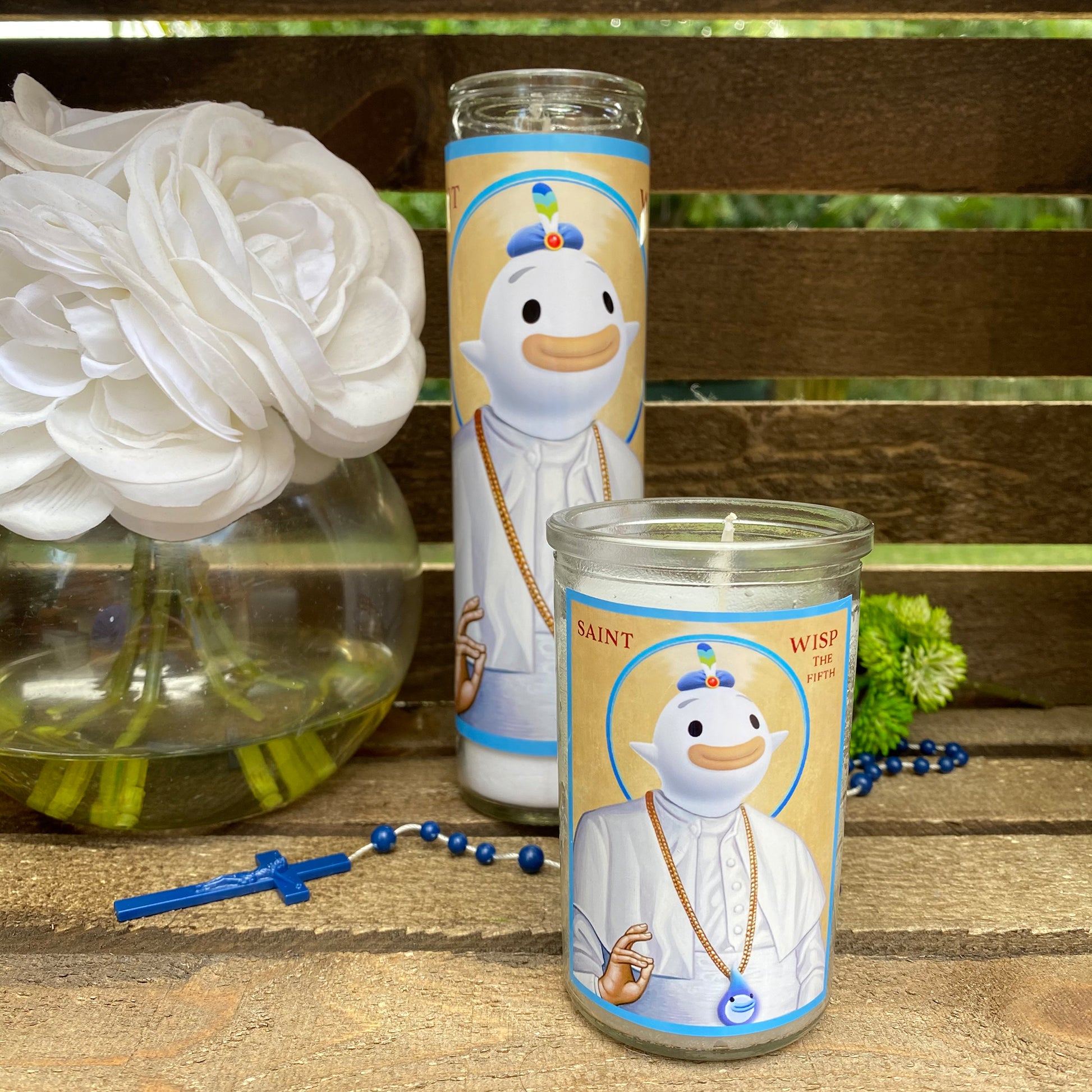 a couple of candles sitting on top of a wooden table