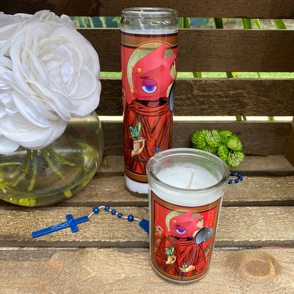 a couple of candles sitting on top of a wooden table