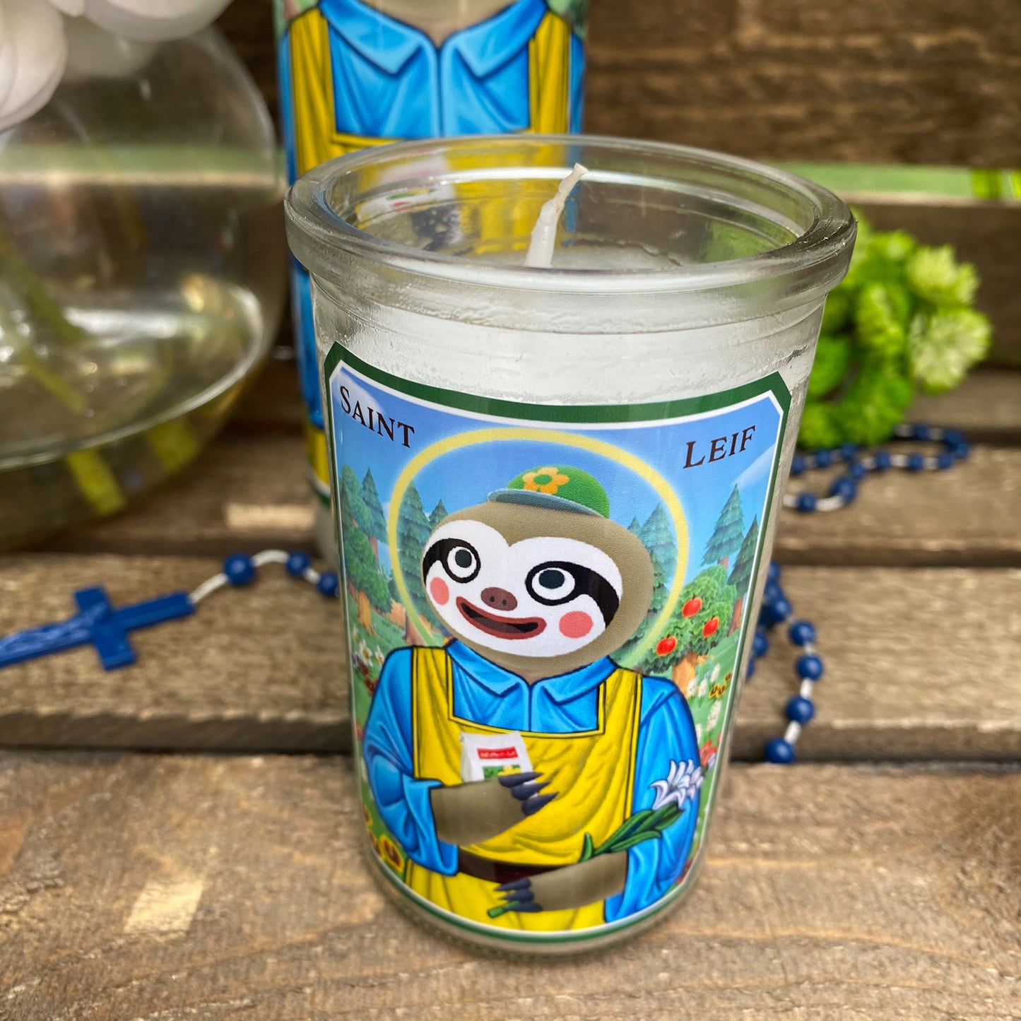 a cup with a sloth on it sitting on a table