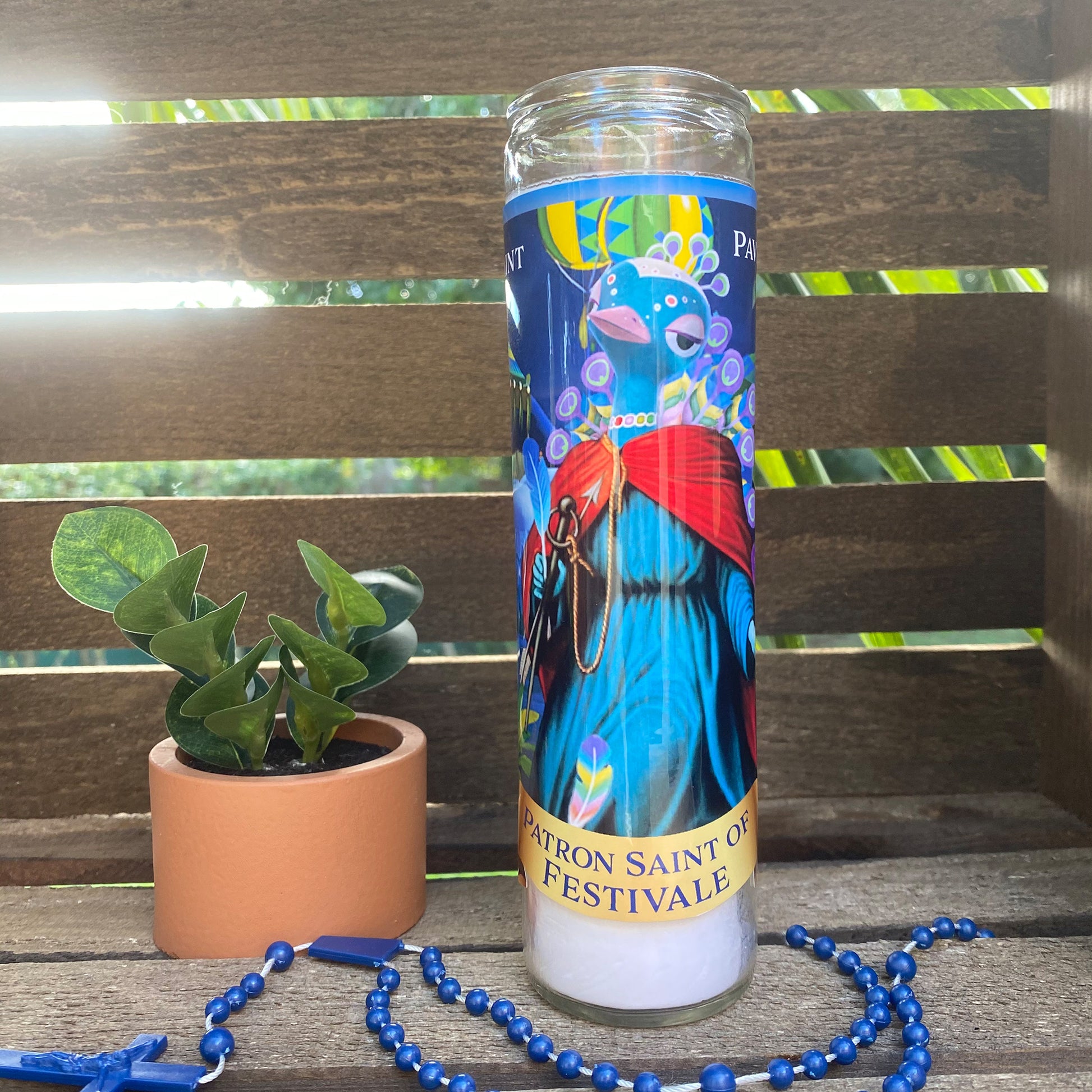 a travel mug sitting next to a plant on a bench