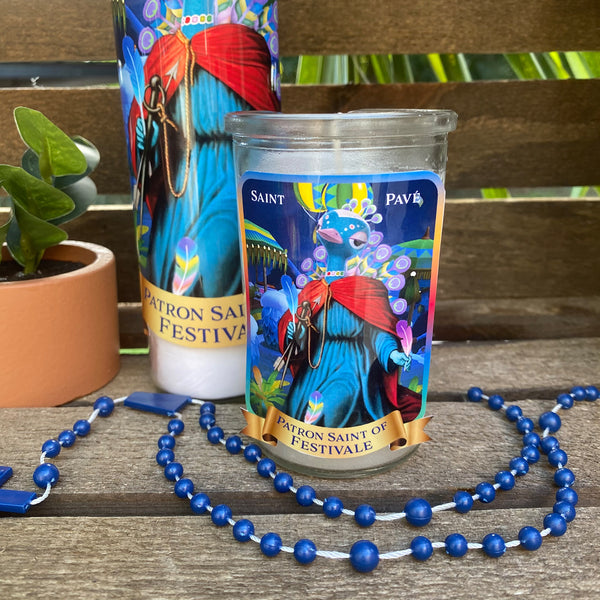 a candle and beads on a wooden table