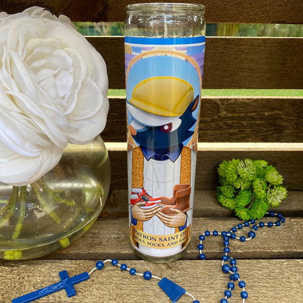 a rosary, a flower, and a glass on a table