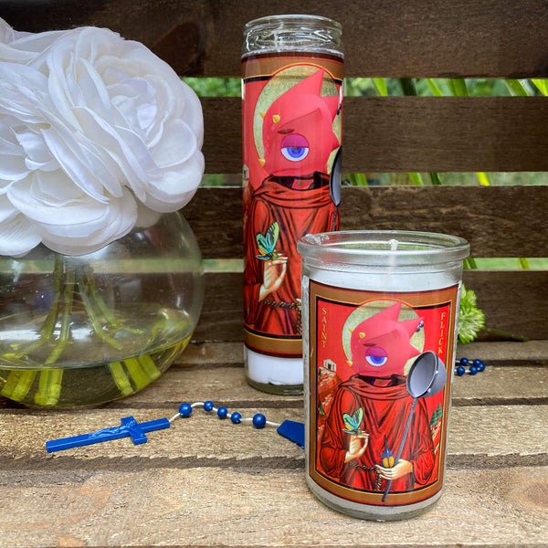 a couple of candles sitting on top of a wooden table