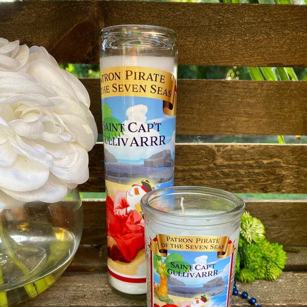 a couple of candles sitting on top of a wooden bench