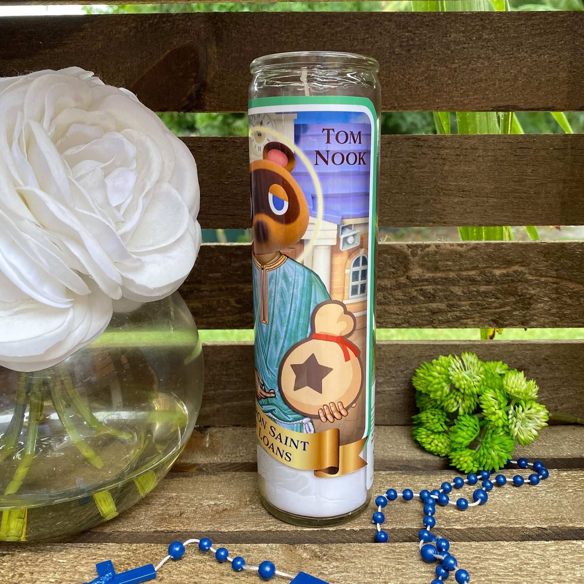 a bottle of toothpaste next to a flower and beads