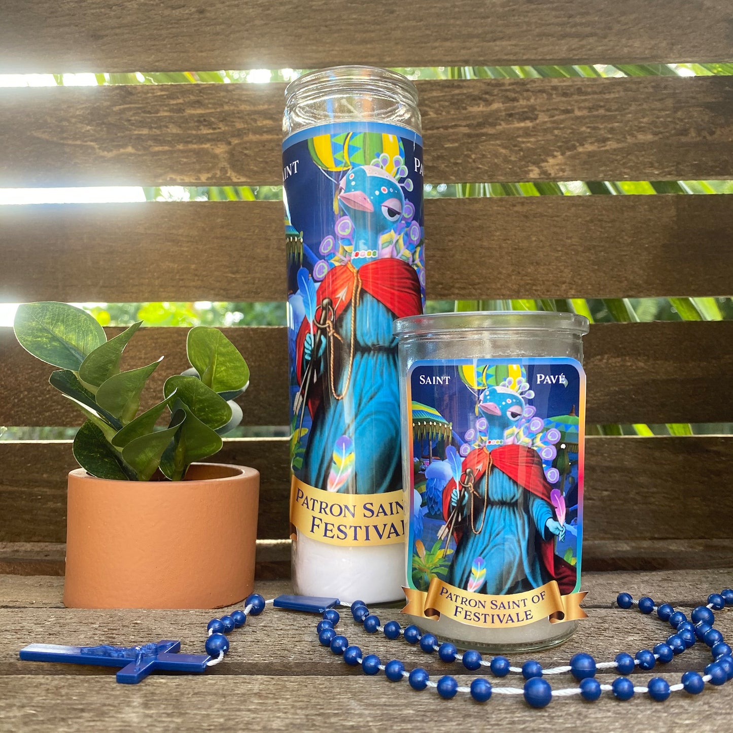 a candle and beads on a wooden bench