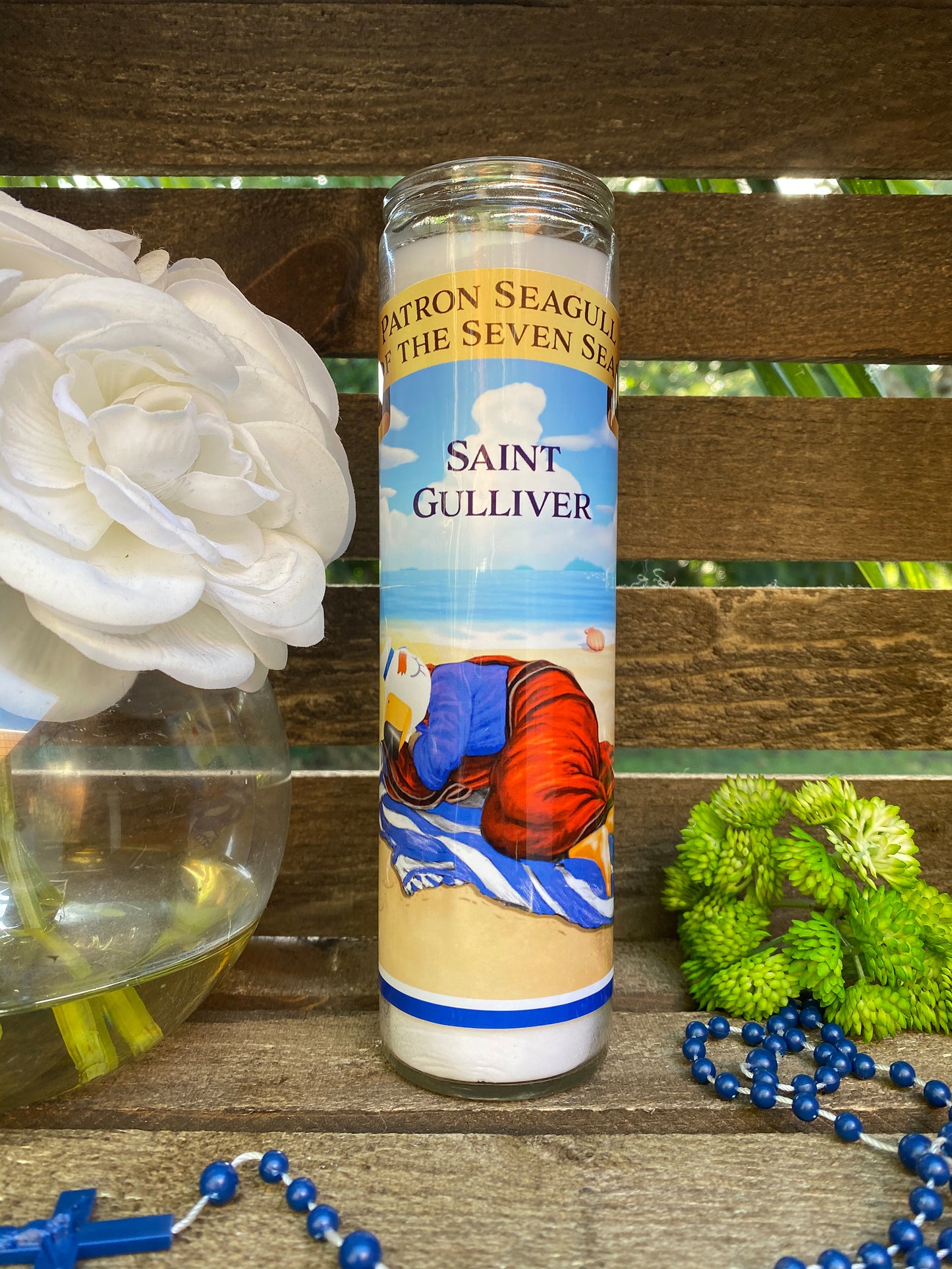 a bottle of saint gulliver next to a flower