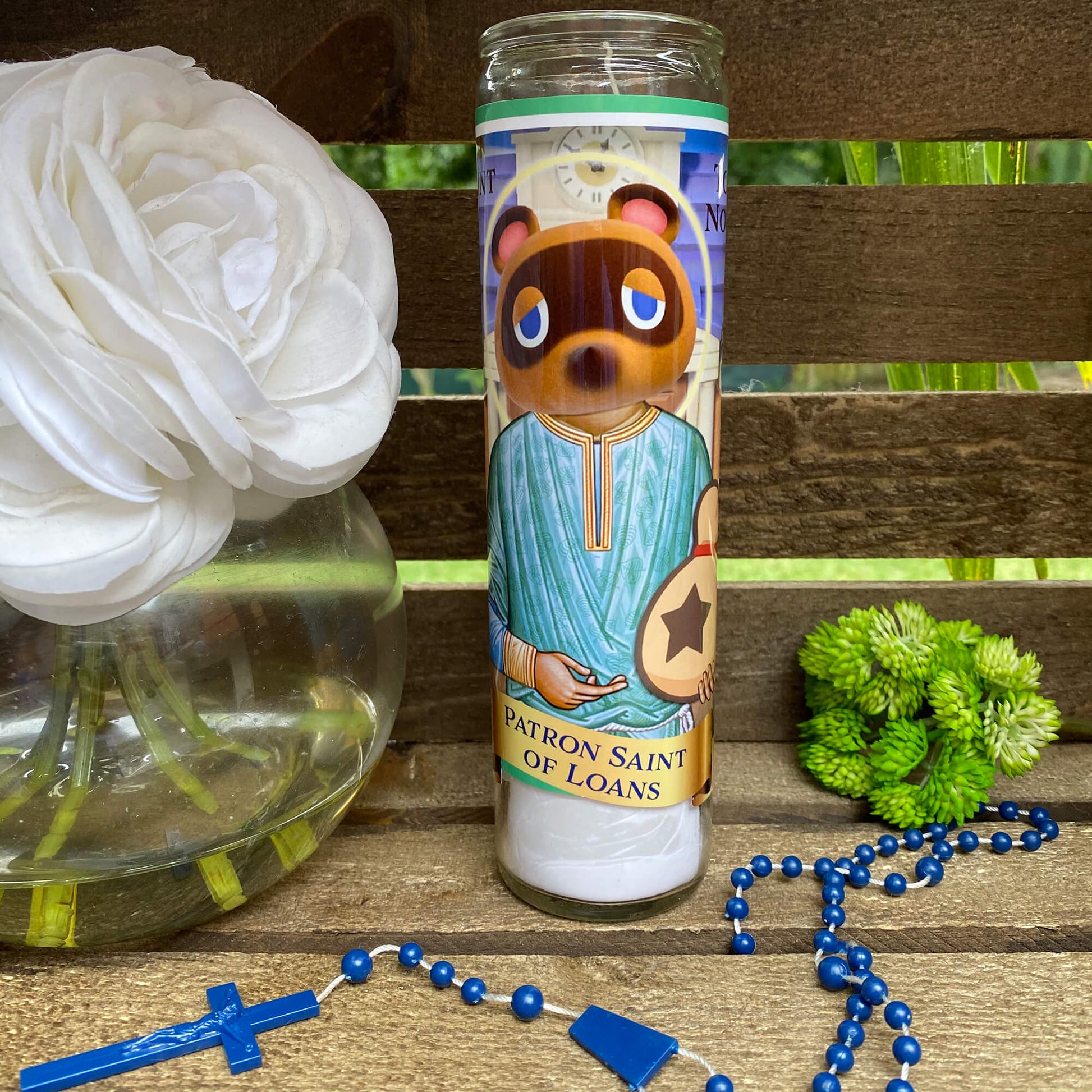 a bottle with a picture of a bear on it next to a rosary and a