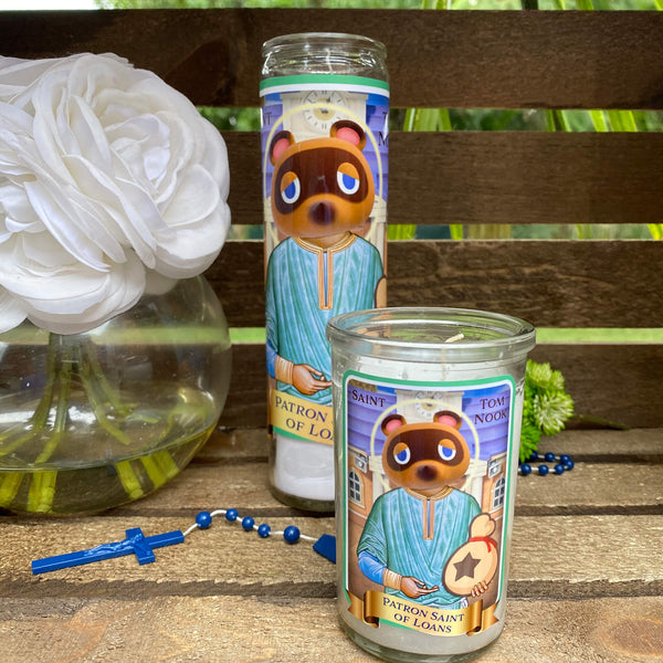 a couple of candles sitting on top of a wooden table