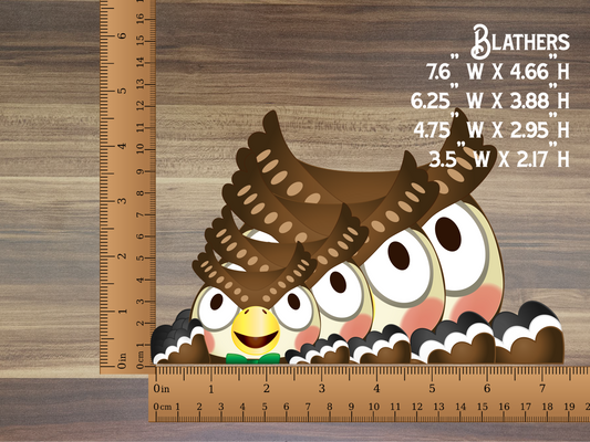 a group of owls sitting on top of each other next to a ruler