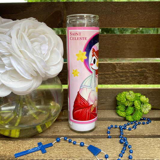 a candle and some flowers on a bench