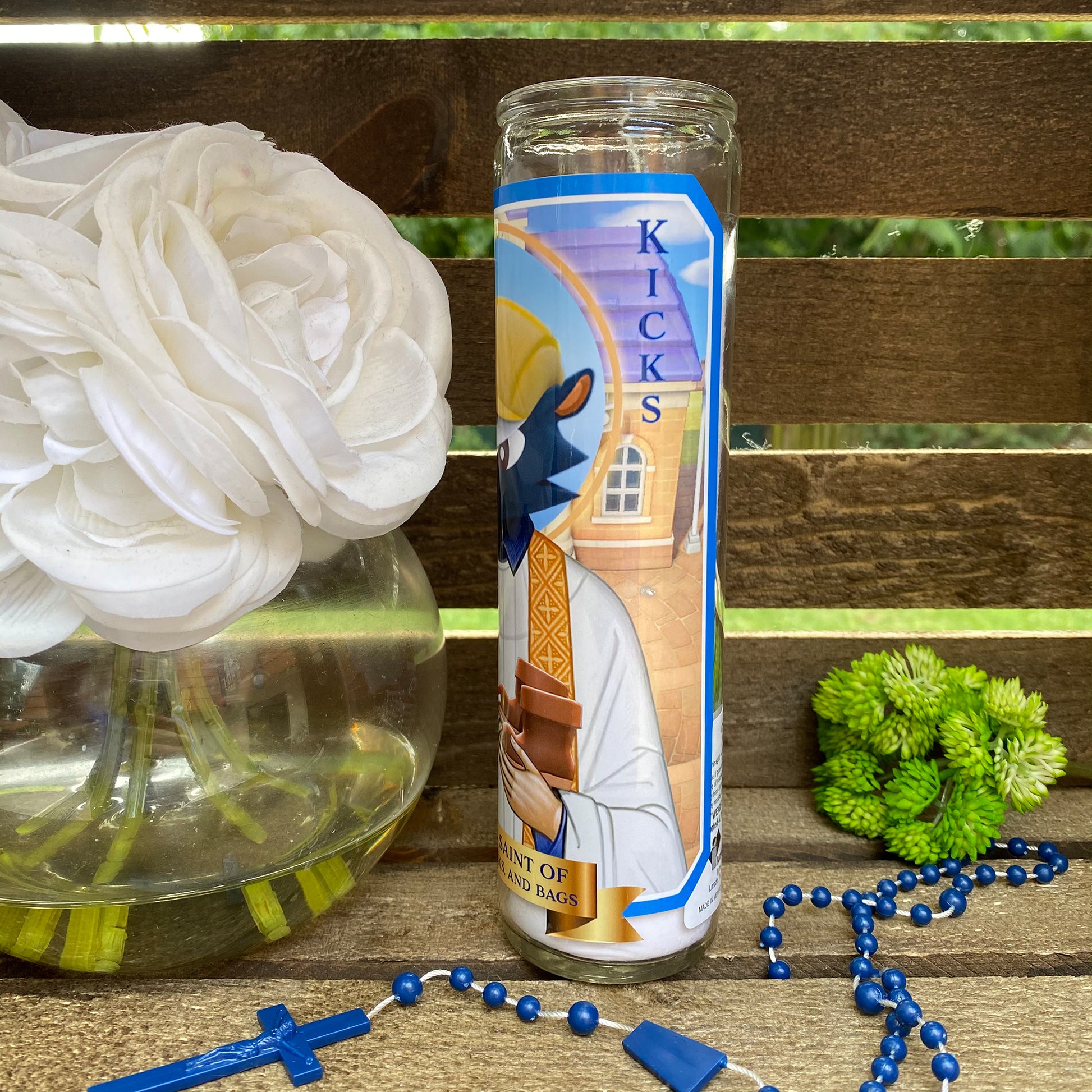 a vase with flowers and a rosary on a table