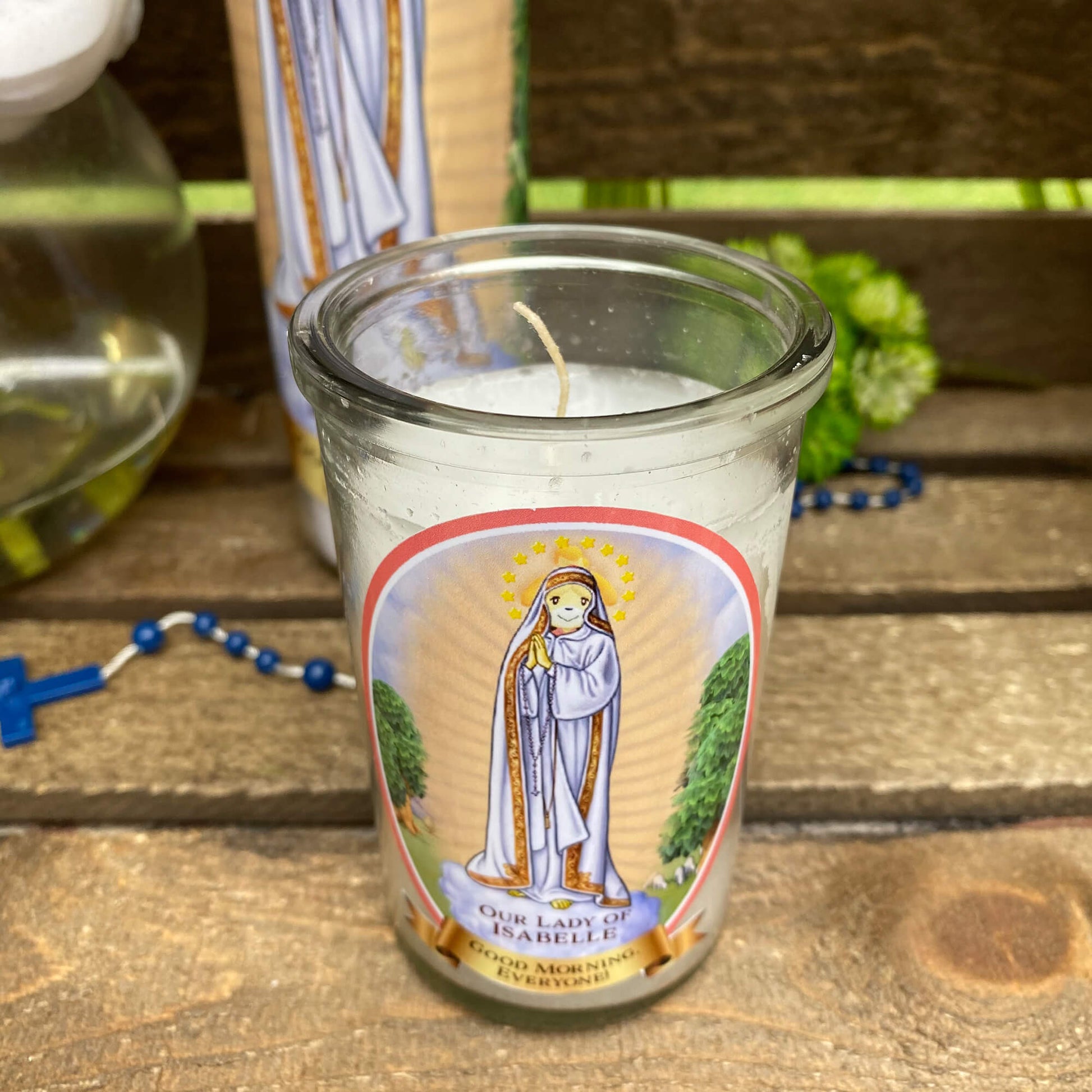 a candle with a picture of the virgin mary on it