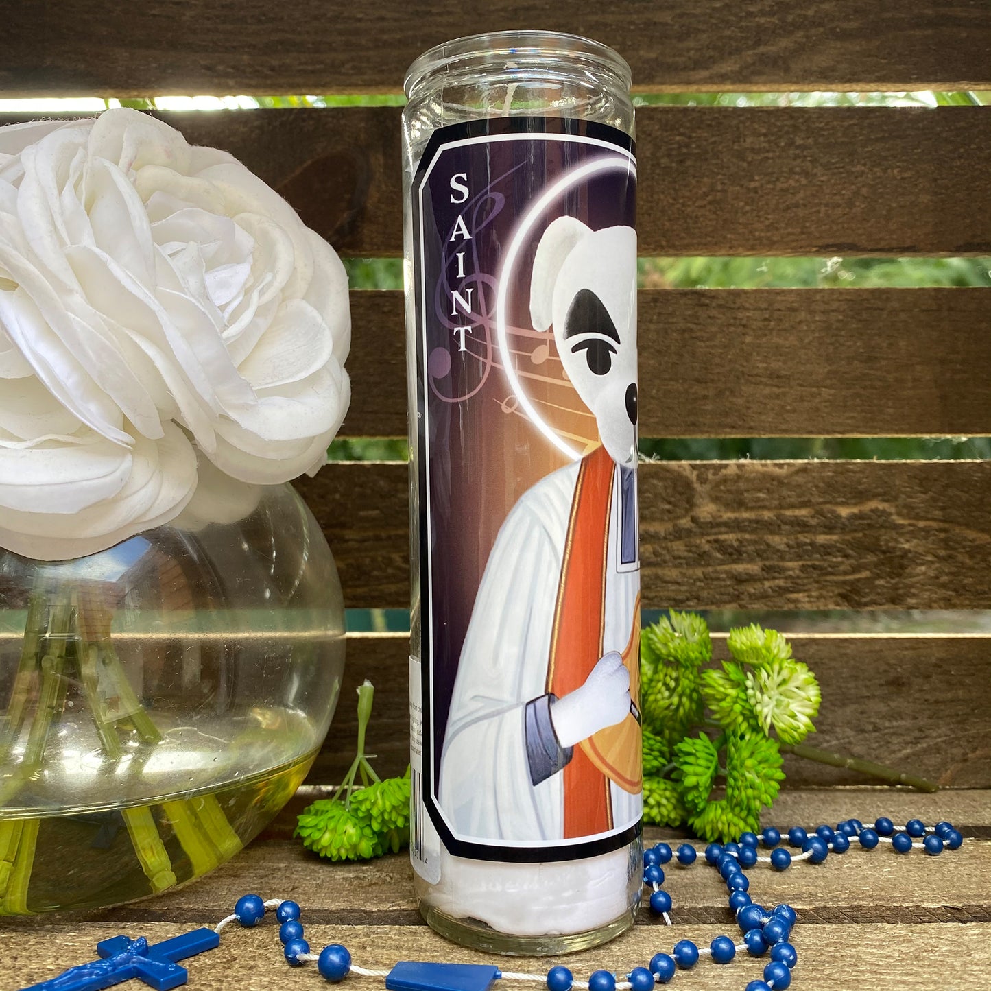 a candle with a picture of a saint on it